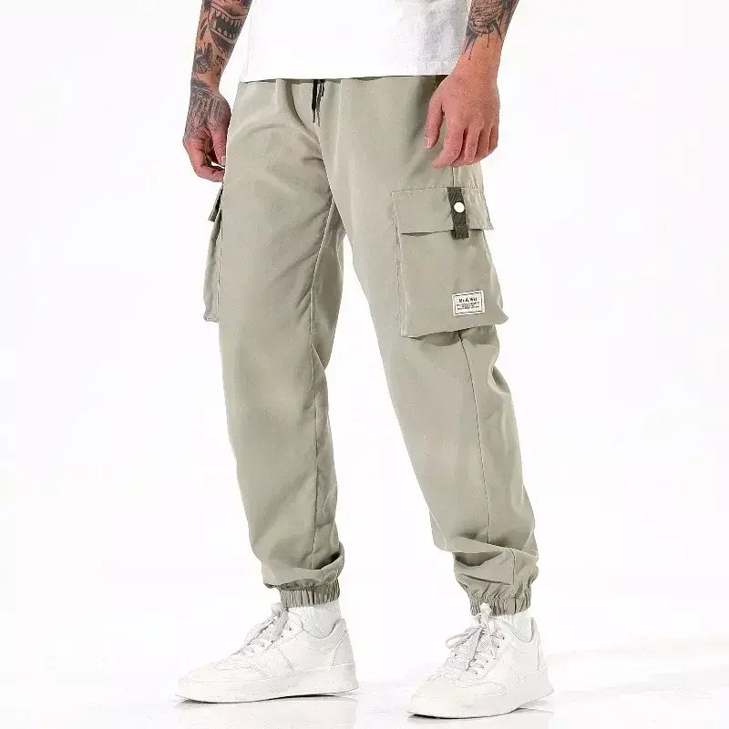 Calça masculina casual de pesca ao ar livre, à prova de vento, respirável, multi pacote, solta, confortável, para todas as estações, casual, versátil, esportiva
